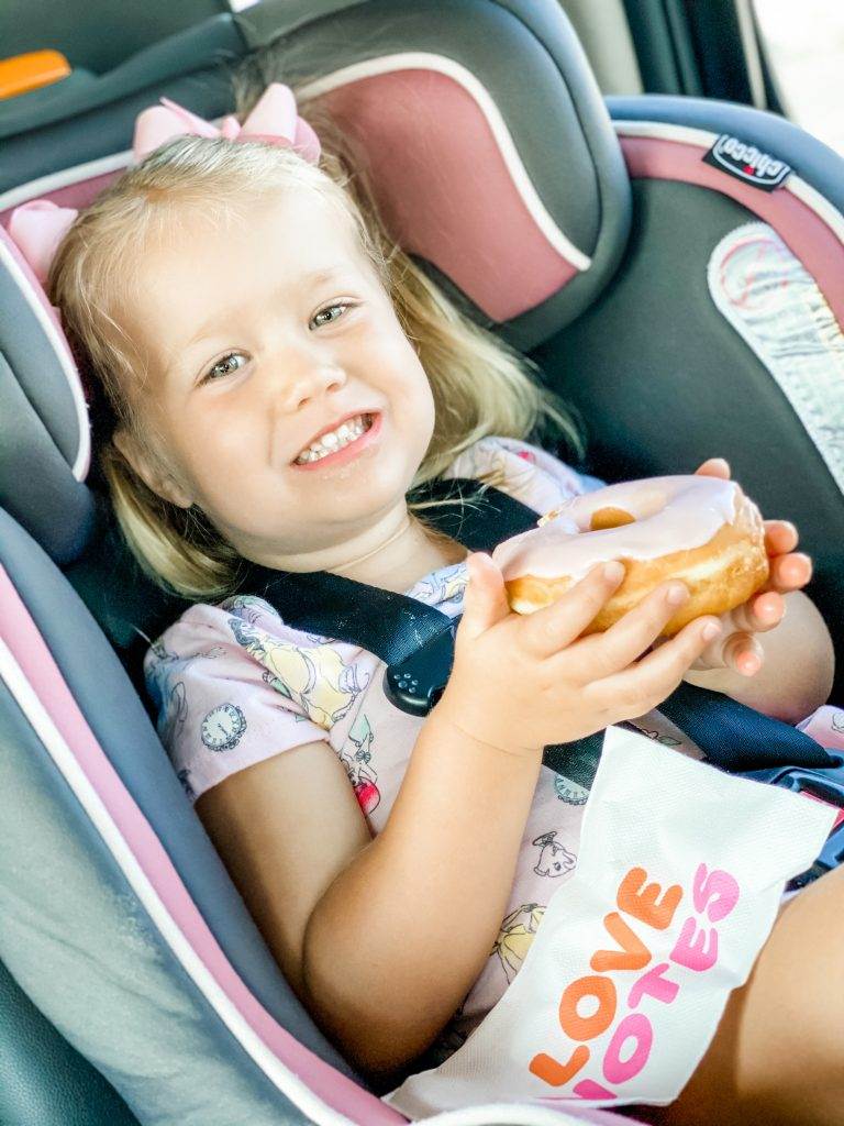 Big smile from this little girl holding her doughnut