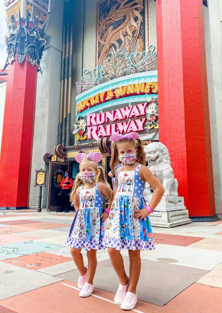 Runway Railway is the background with two girls in the Toy Story dresses.