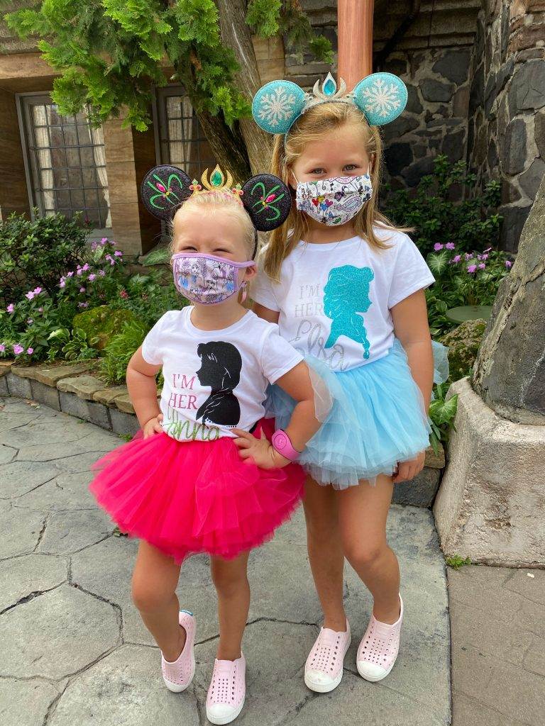 Young girls wearing blue and pink tutus, representing Anna and Elsa. 